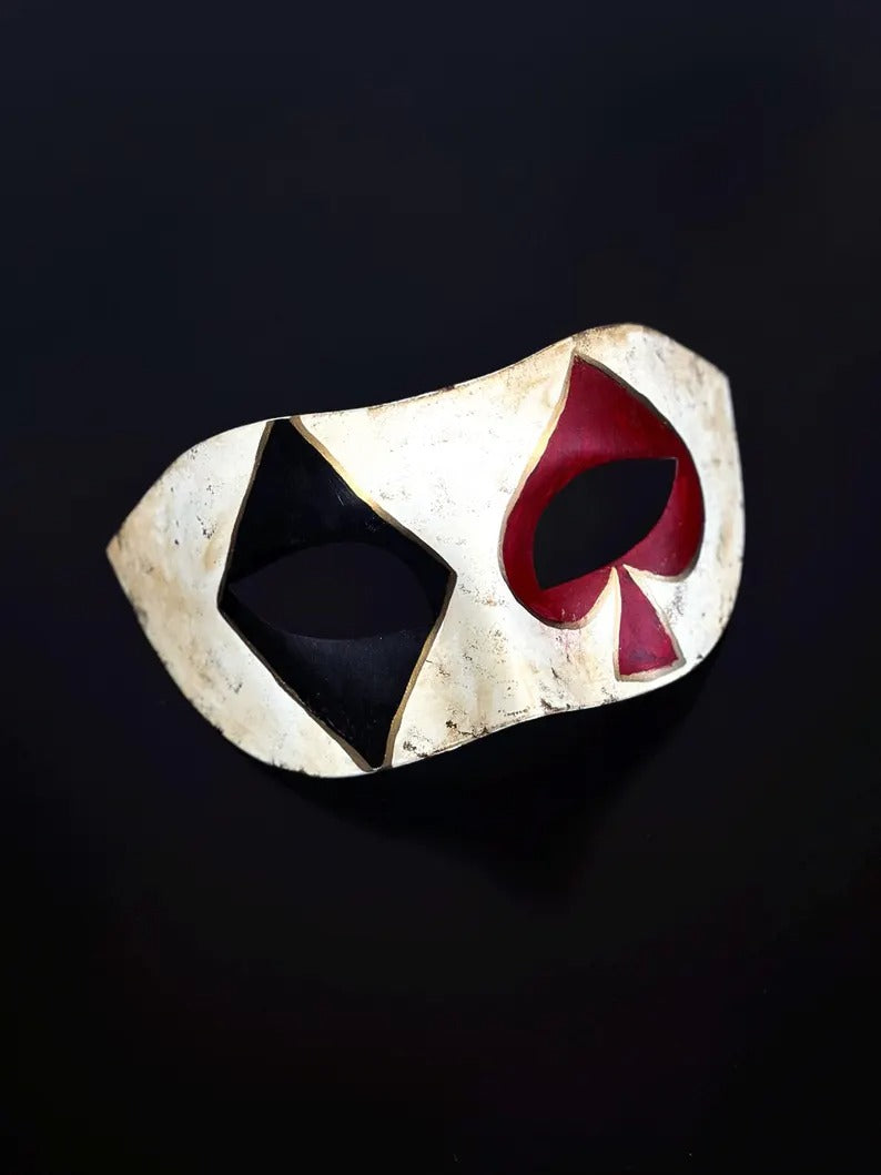 Venetian Harlequin masquerade mask with distressed ivory finish, black diamond, and red spade design, perfect for Carnival and Halloween.