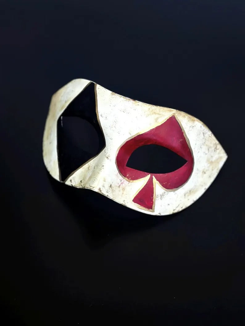 Venetian Harlequin masquerade mask with distressed ivory finish, black diamond, and red spade design, perfect for Carnival and Halloween.