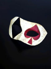Venetian Harlequin masquerade mask with distressed ivory finish, black diamond, and red spade design, perfect for Carnival and Halloween.