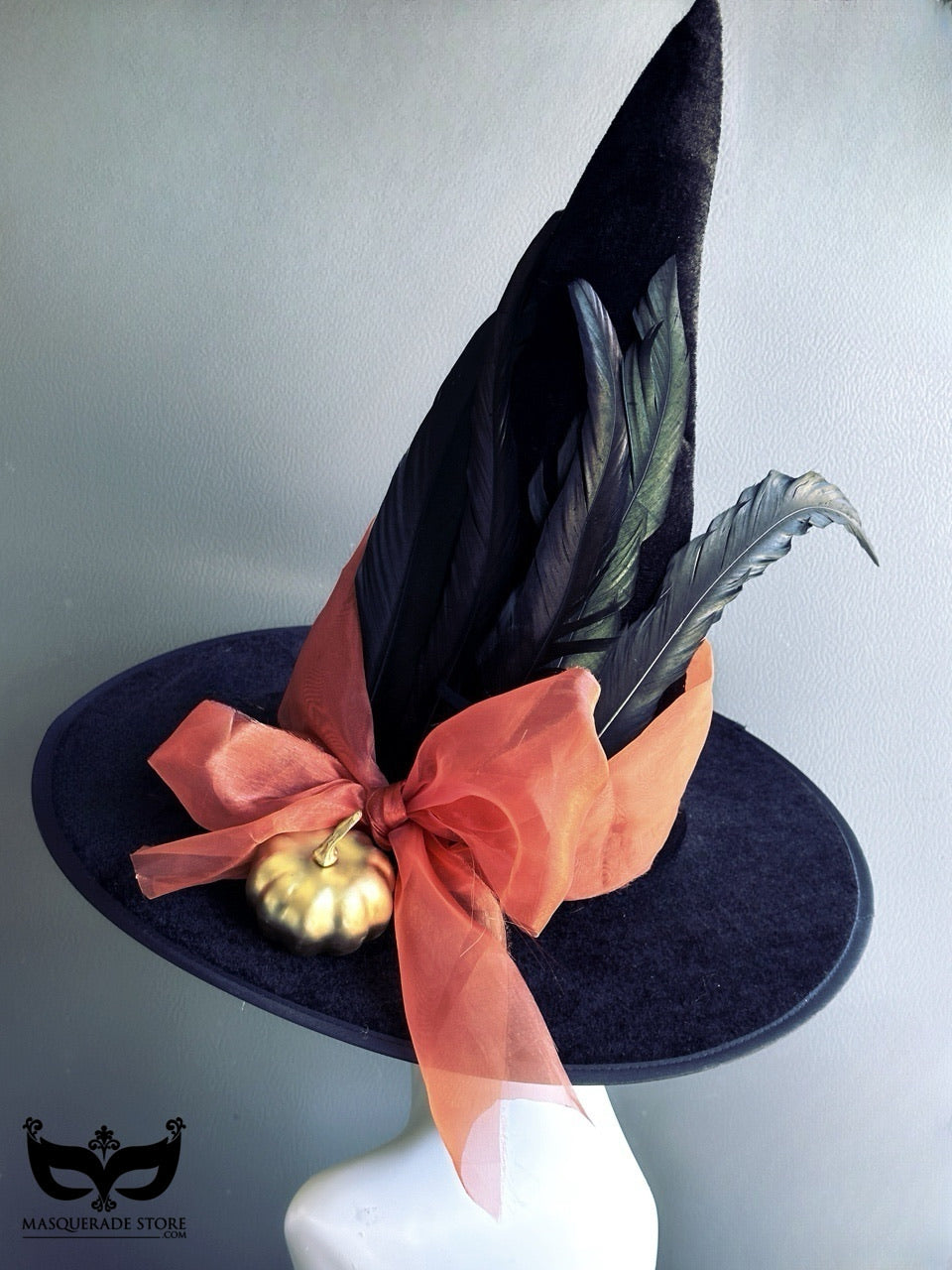 Halloween black witch hat with long feathers, orange bow, and gold pumpkin accent for fall costume