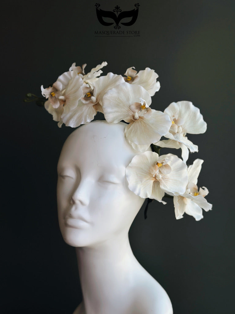 Elegant ivory cream orchid fascinator featuring cascading artificial orchid blooms mounted on a lightweight satin-covered headband. Perfect for Kentucky Derby, Royal Ascot, wedding guest attire, church services, tea parties, bridal showers, Easter celebrations, garden parties, race day fashion, and sophisticated formal occasions.