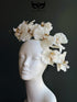 Elegant ivory cream orchid fascinator featuring cascading artificial orchid blooms mounted on a lightweight satin-covered headband. Perfect for Kentucky Derby, Royal Ascot, wedding guest attire, church services, tea parties, bridal showers, Easter celebrations, garden parties, race day fashion, and sophisticated formal occasions.