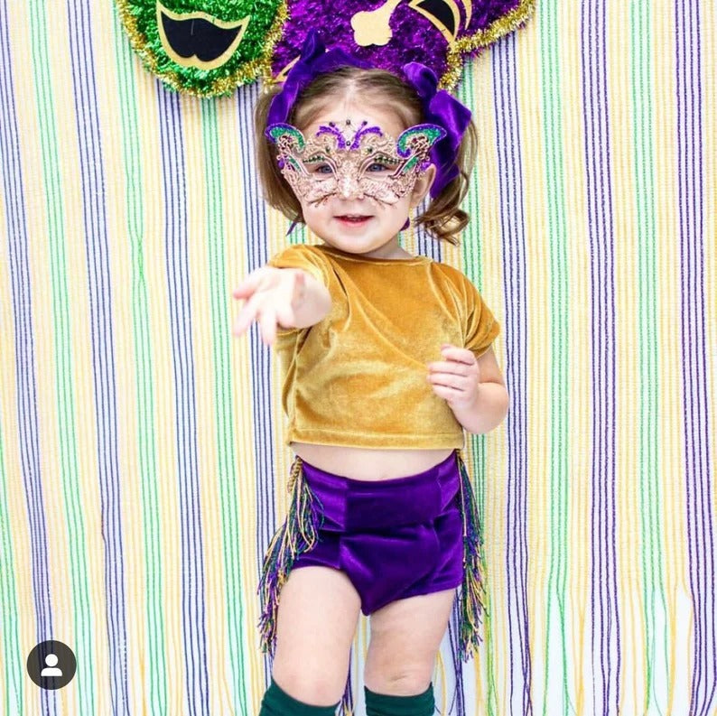 Child-sized Mardi Gras masquerade mask with gold filigree and glitter accents.