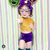 Child-sized Mardi Gras masquerade mask with gold filigree and glitter accents.