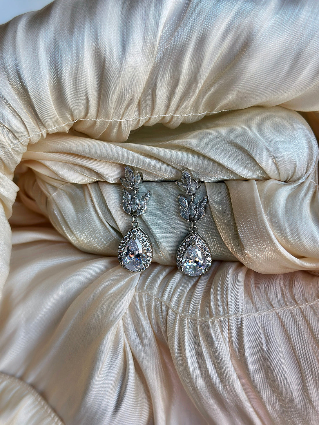 Drop earrings with crystal-studded laurel leaves and teardrop accents.