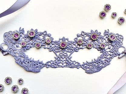 Lavender embroidered lace Venetian masquerade eye mask featuring amethyst crystal rhinestones and satin ribbon ties. Perfect for masquerade balls, Mardi Gras celebrations, weddings, bridal showers, black tie galas, Renaissance festivals, opera performances, cosplay, Valentine&