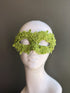 Lime green lace masquerade mask with floral embroidery, bead embellishments, and botanical-inspired Venetian eye-mask detailing