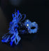 Royal blue lace masquerade mask with crystals and feather accent for formal balls and gala events.
