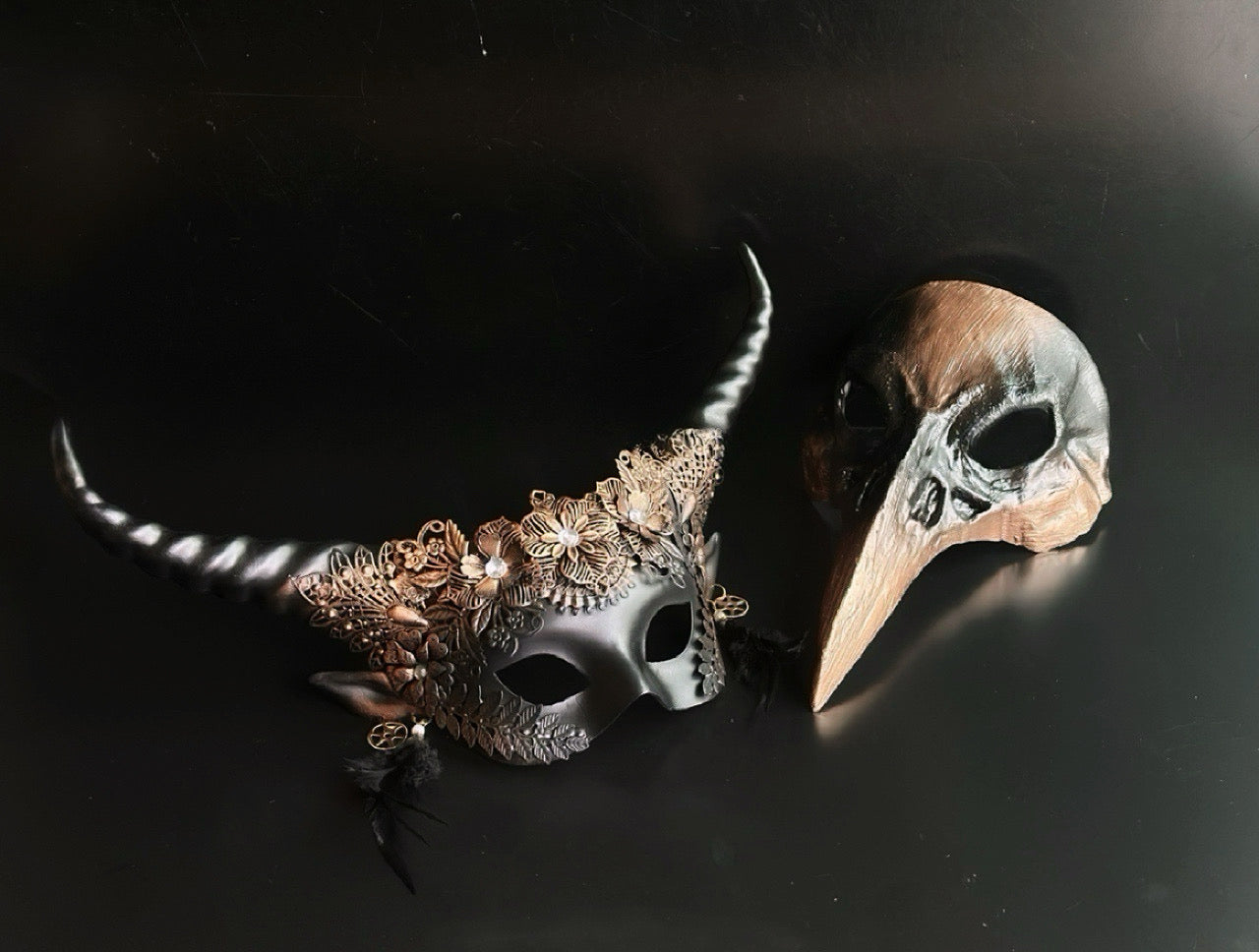 Gothic Halloween couples mask set with horned floral mask and plague doctor beak mask.