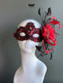 Red lace masquerade mask with crystal details and black feather accent styled for masquerade balls and evening galas.