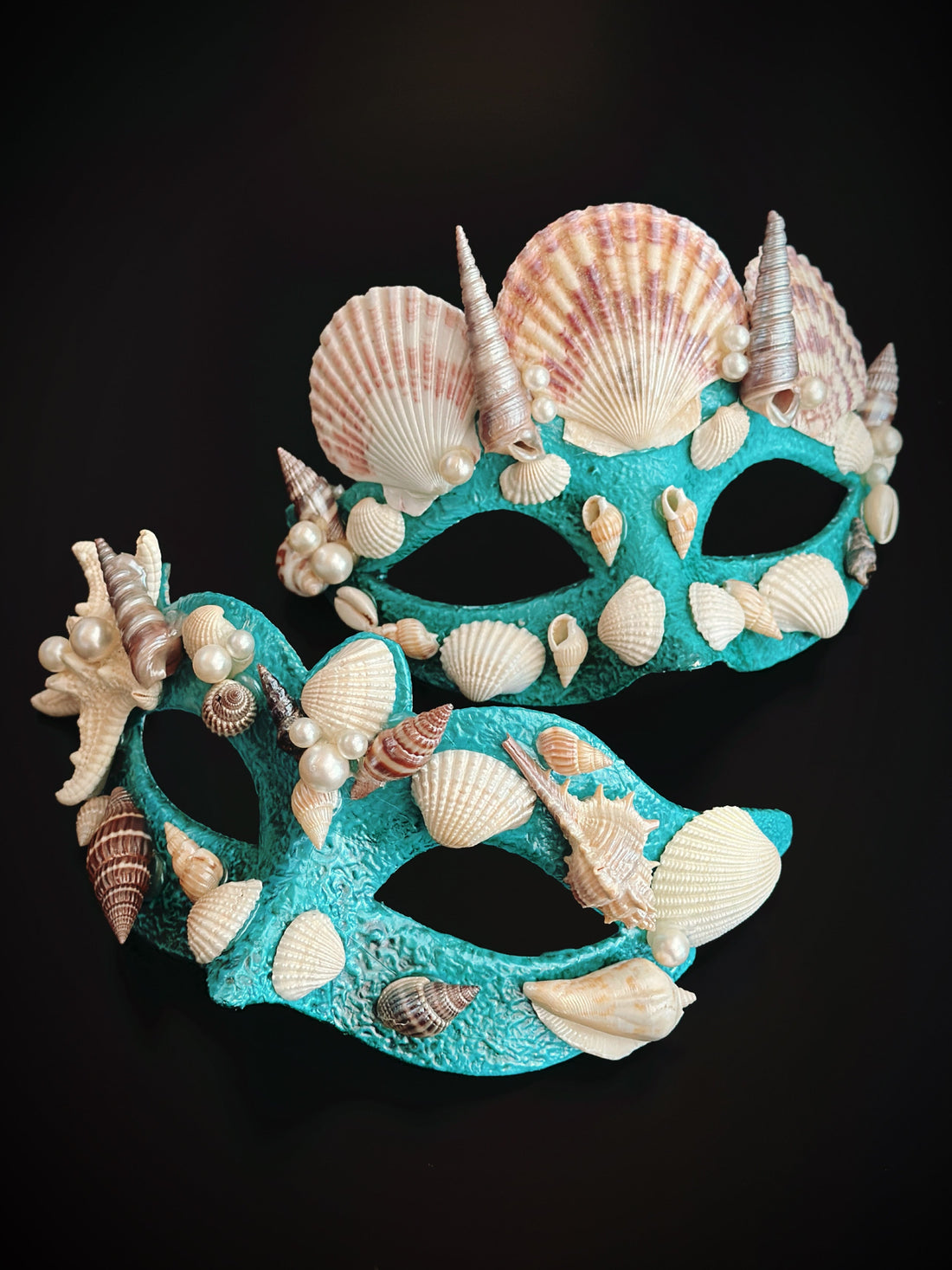 Turquoise couples masquerade mask set decorated with seashells, pearls, and starfish accents.