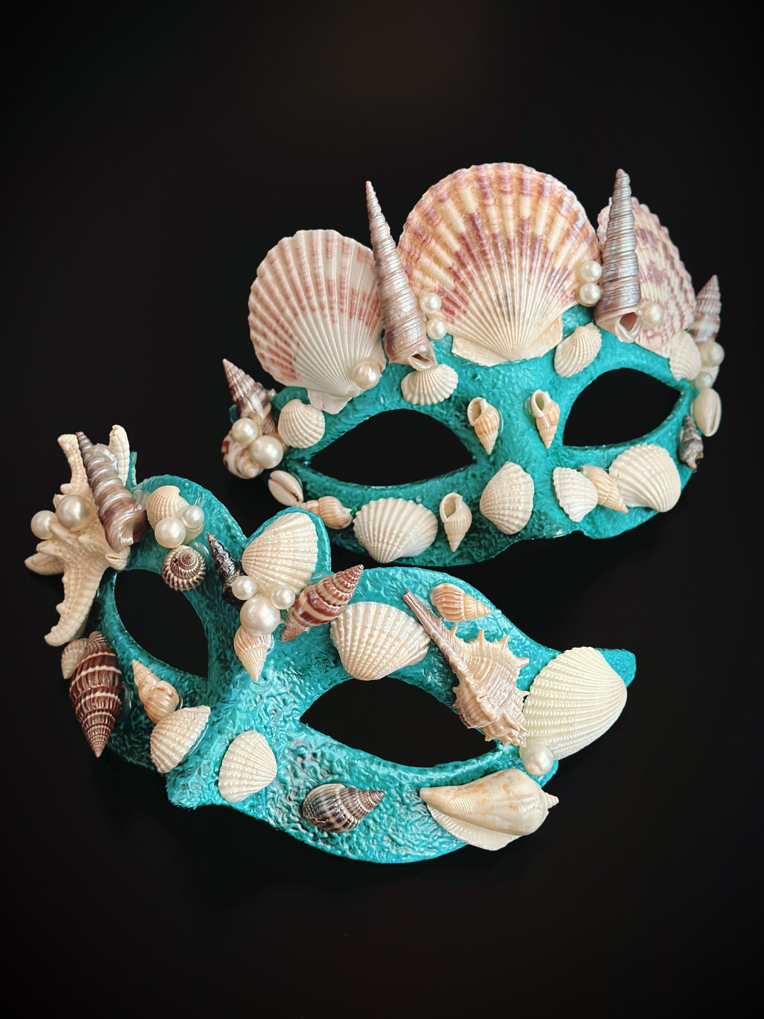 Turquoise couples masquerade mask set decorated with seashells, pearls, and starfish accents.
