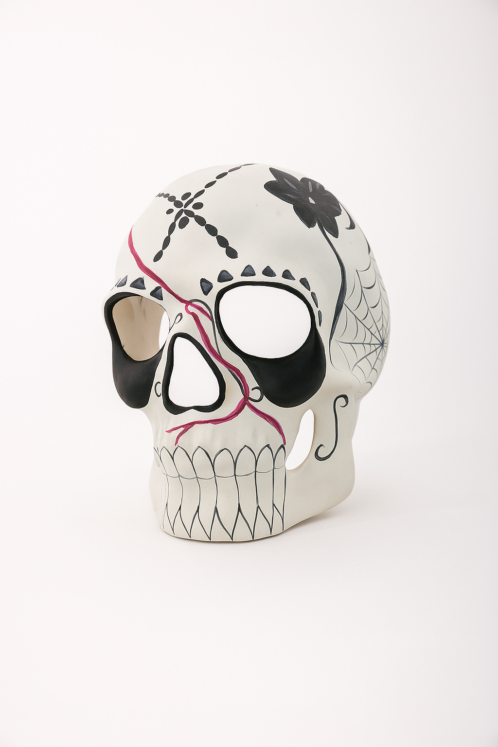 Minimalist sugar skull masquerade mask with floral and spiderweb motifs.