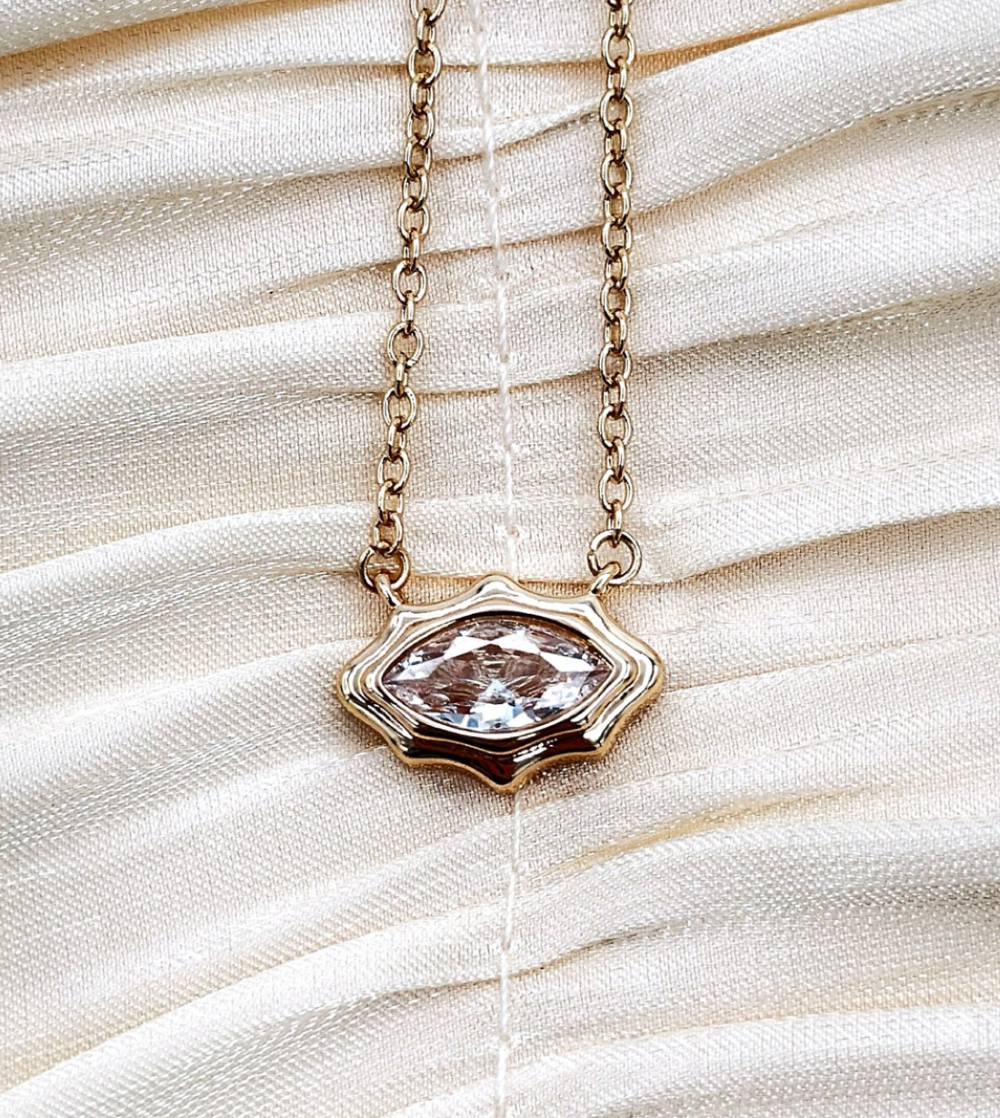 Crystal pendant framed with gold on a gold plated chain.
