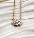 Crystal pendant framed with gold on a gold plated chain.
