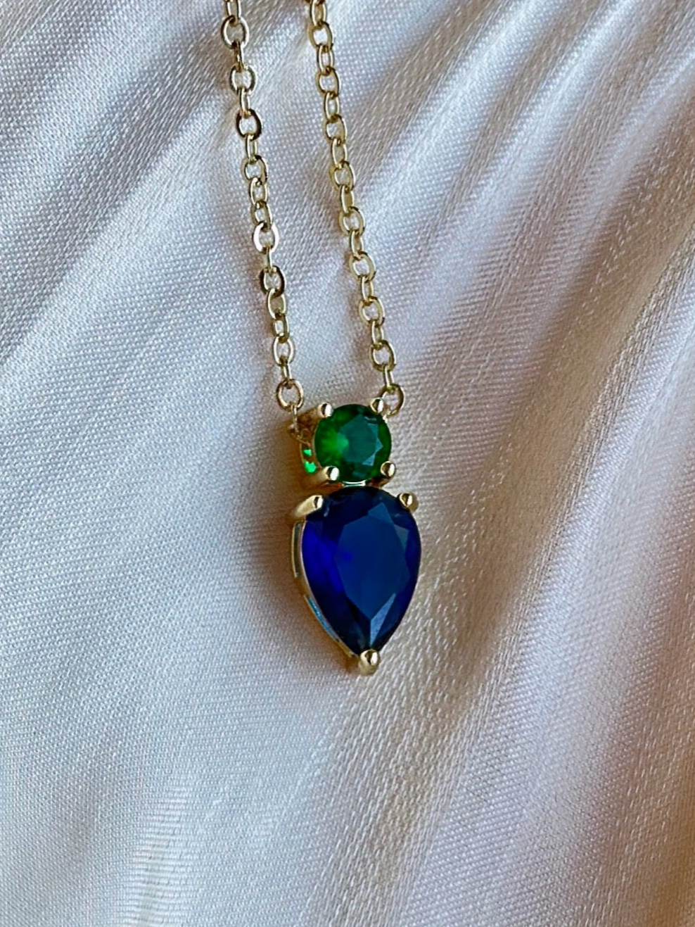 Necklace with a blue and green teardrop pendant.