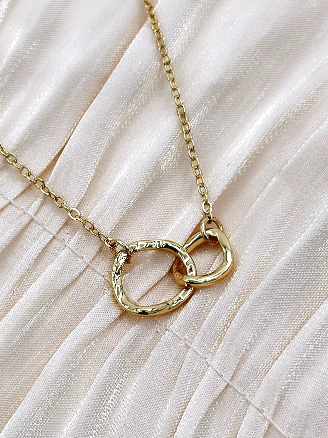 Gold plated necklace with interlocking rings.