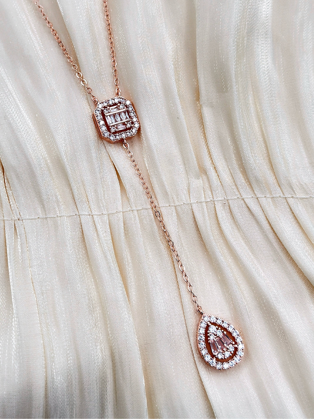 Rose gold necklace with crystal pendants.