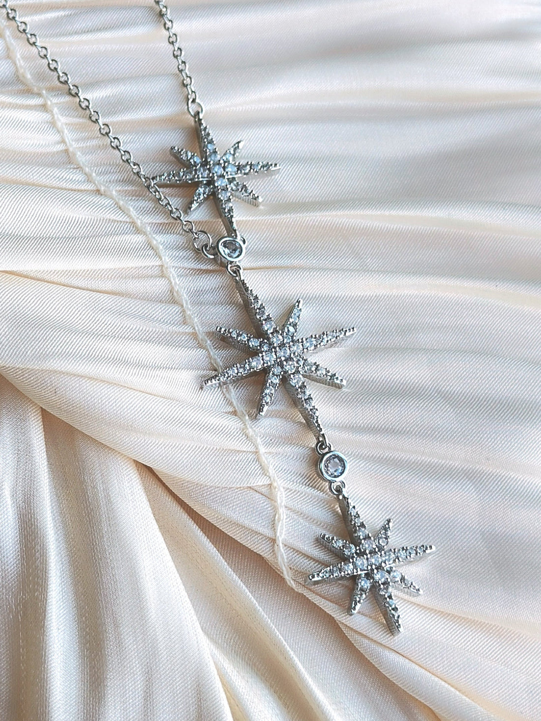 Silver star necklace with clear crystal stones.