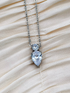 Pear and circle cut crystals on a silver-plated chain.
