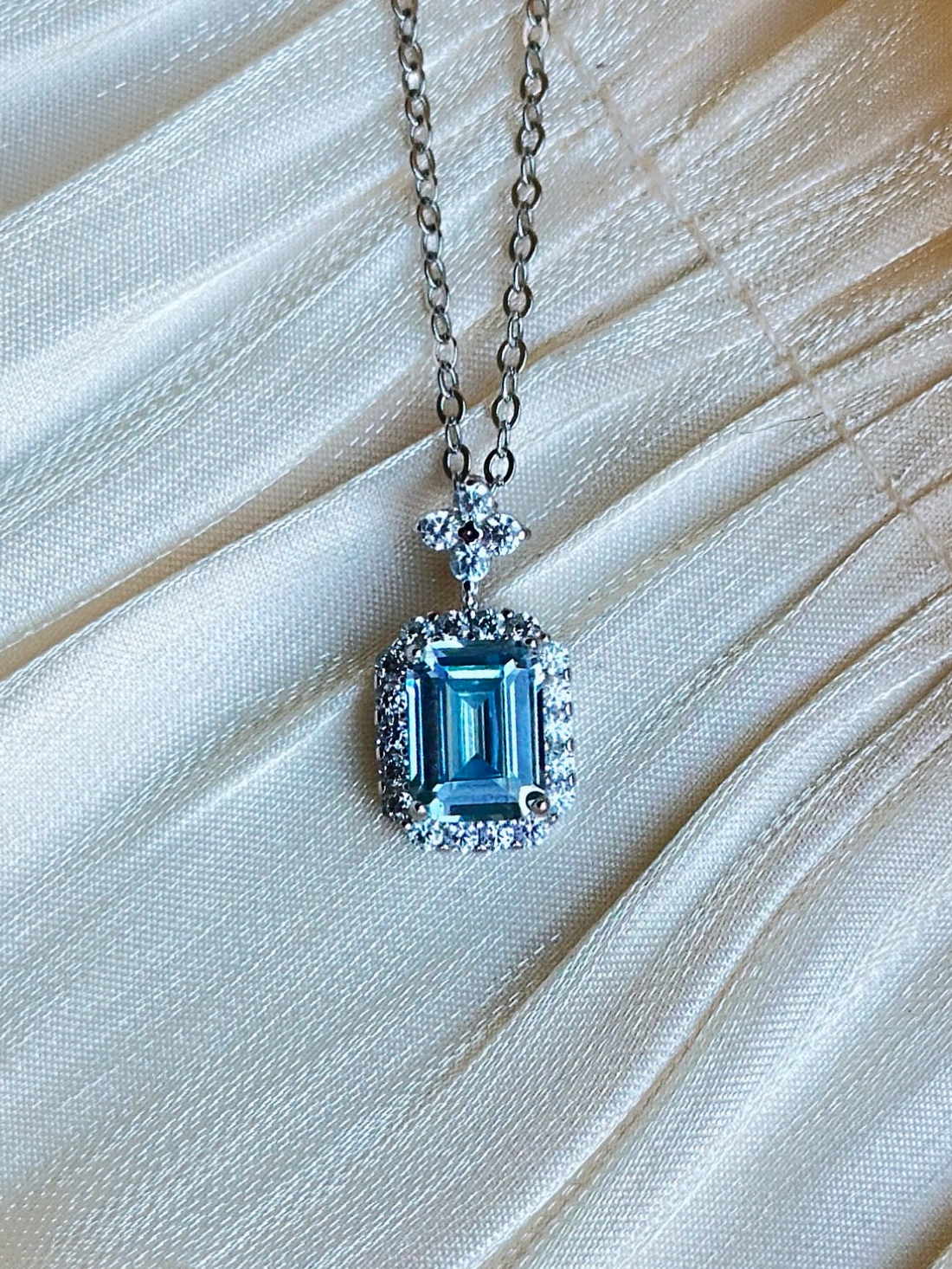 Necklace with a blue gemstone pendant.