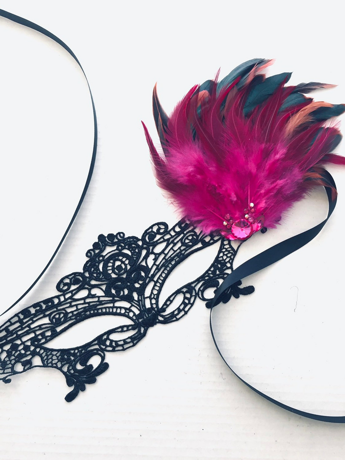 Black and pink couples masquerade mask set with lace, feathers, and rhinestone details.