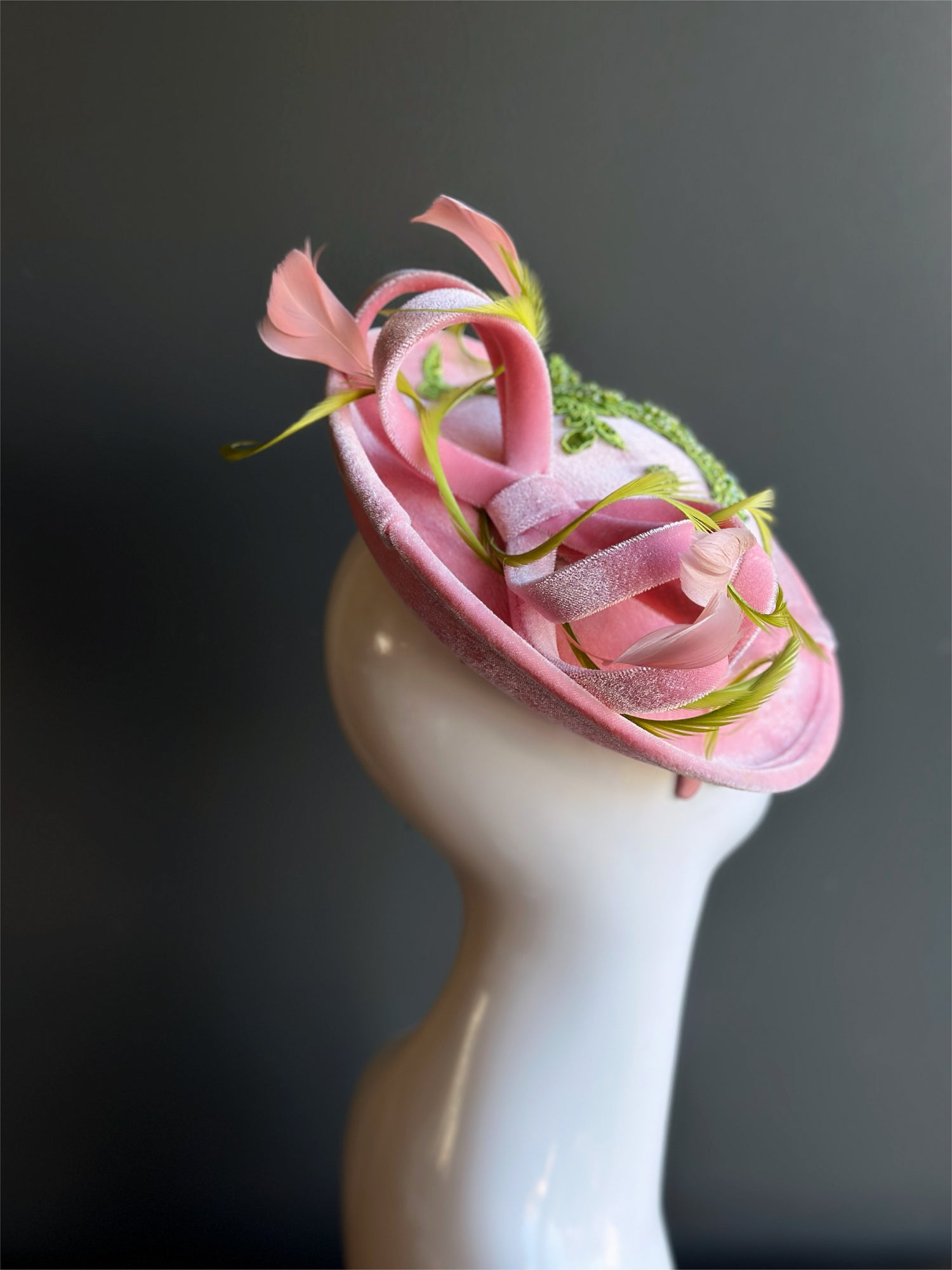 Velvet tea party fascinator hat with green beaded accents.