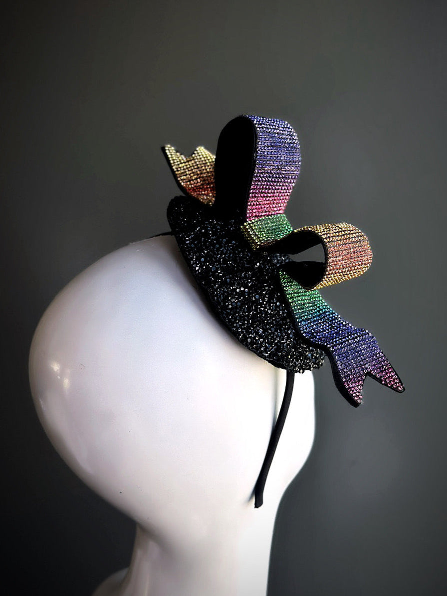 Rainbow ribbon loop fascinator hat with glittery black beaded base for Pride

