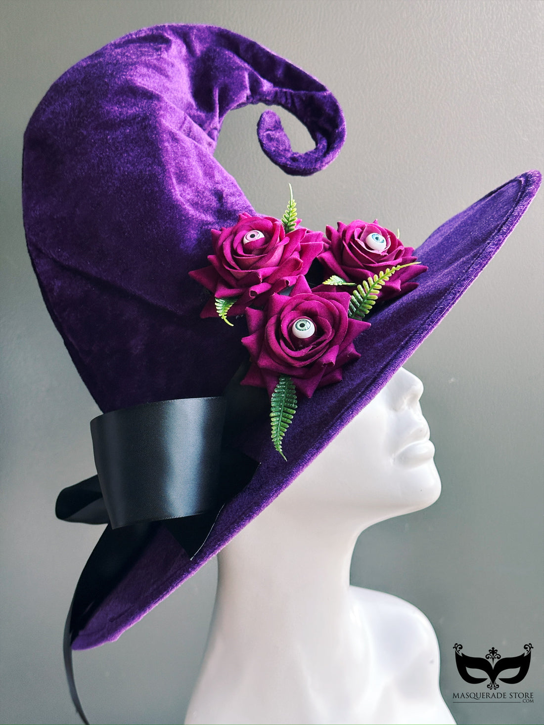 Velvet curly witch hat in purple with magenta eyeball flowers and ribbon bow, gothic Halloween costume accessory