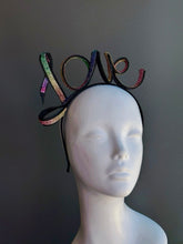 Rainbow rhinestone LOVE headband with multicolor crystal lettering on a black metal headband, perfect for Pride Month, LGBTQ+ celebrations, rainbow festivals, Pride parade outfits, drag shows, music festivals, equality marches, queer events, and colorful statement fashion.