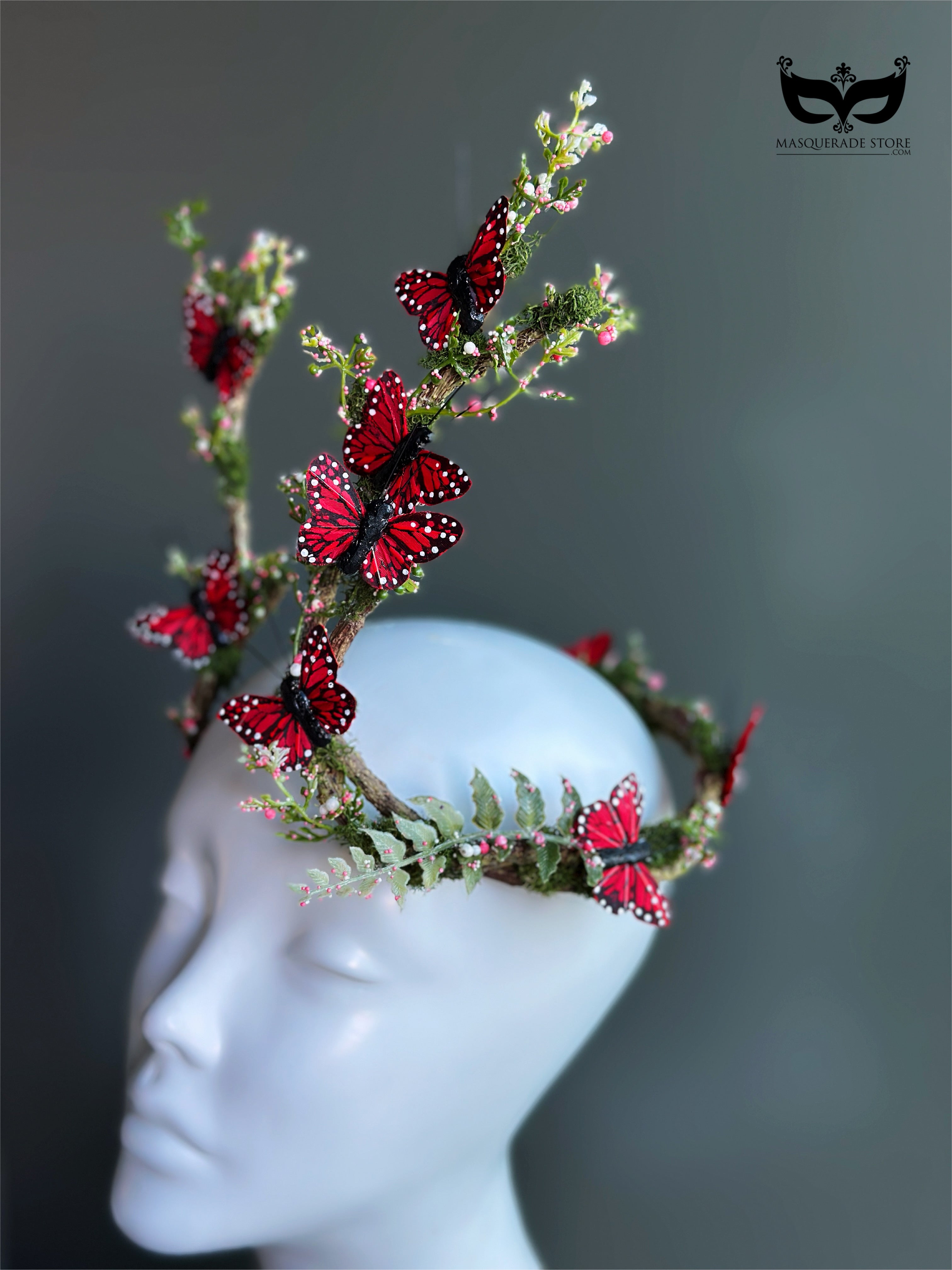 Red butterfly antler headpiece with moss greenery and monarch style wings for fantasy costumes and masquerade events