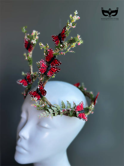 Red butterfly antler headpiece with moss greenery and monarch style wings for fantasy costumes and masquerade events