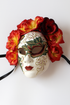 Red floral full-face sugar skull mask with embroidery and blossoms for Day of the Dead and masquerade events.