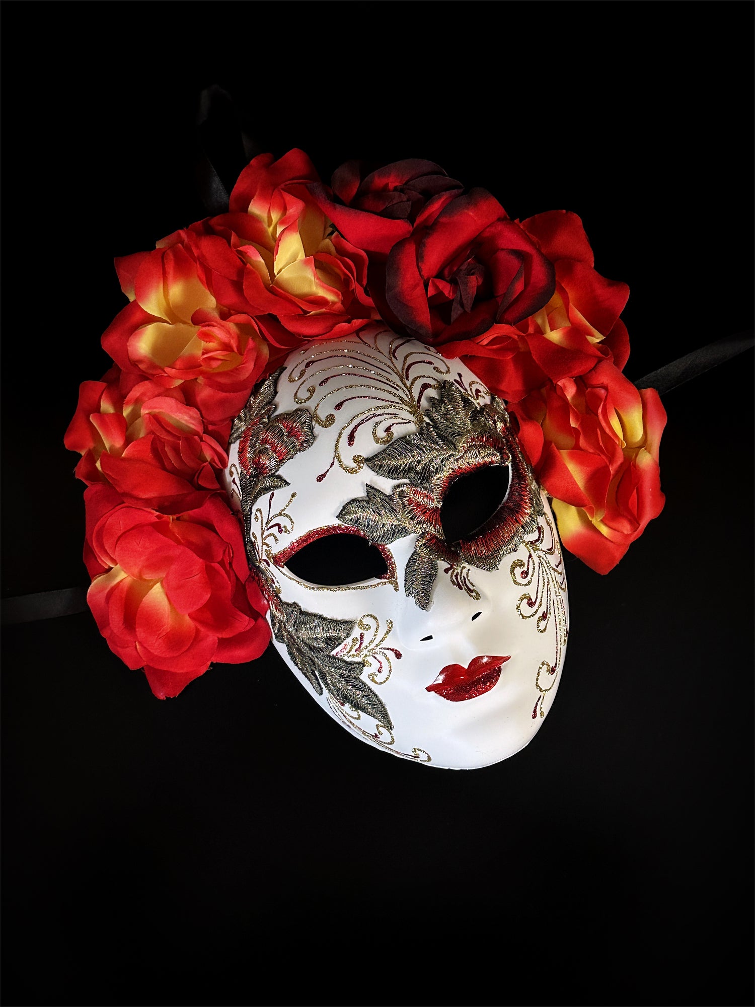 Red floral mask with embroidered detailing, featuring red and yellow flowers, inspired by Venetian craftsmanship

