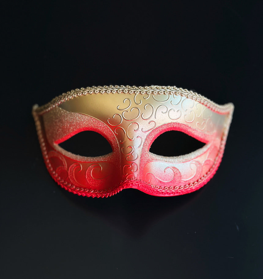 Red and gold ombre Venetian masquerade mask with embossed Baroque scrollwork, glitter eye detailing, and classic Phantom-inspired silhouette
