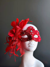 Elegant red lace mask with feathers, rhinestones, and ribbons for Valentine’s, masquerade balls, and prom.