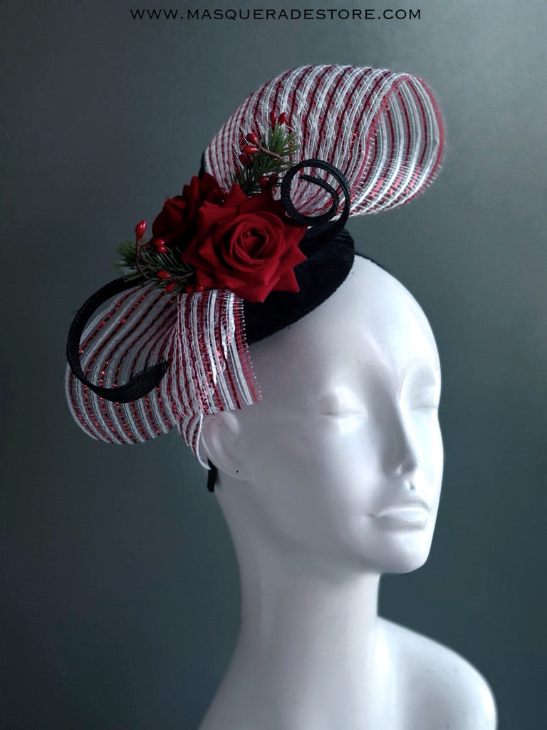 Red rose Christmas fascinator hat with striped mesh bow, greenery, and berry accents.