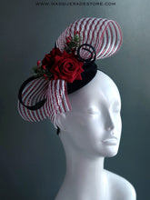Red rose Christmas fascinator hat with striped mesh bow, greenery, and berry accents.