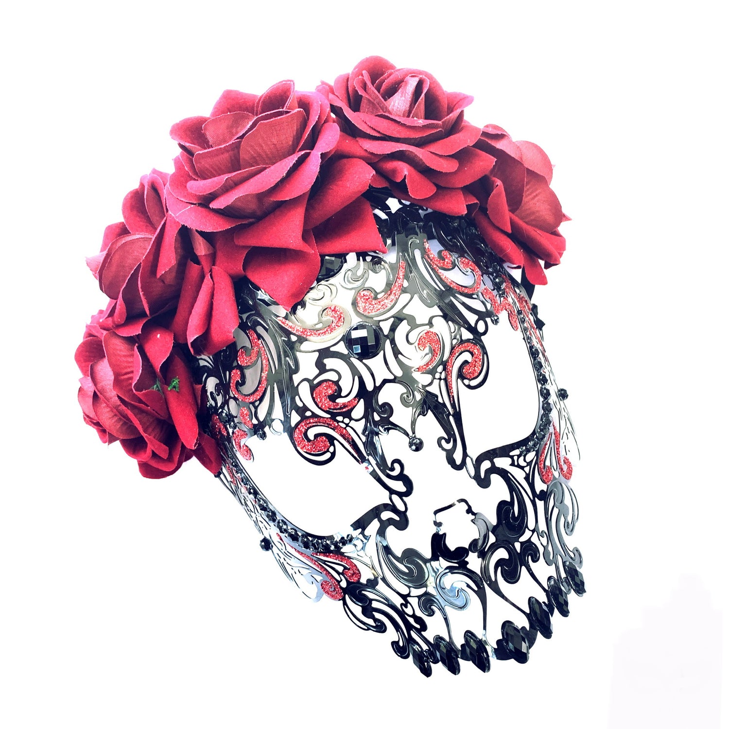 Black metal skull mask adorned with red roses and rhinestones, ideal for Day of the Dead, Halloween, and gothic celebrations.