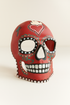 Red sugar skull mask with festive heart and cross design.