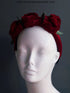 Red velvet floral headband with large fabric roses on a velvet band.