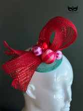Red bow holiday fascinator headband with mesh loops and ornament bead accents on mannequin