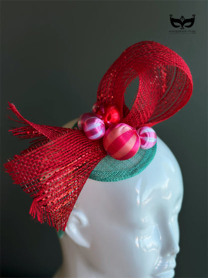 Red bow holiday fascinator headband with mesh loops and ornament bead accents on mannequin