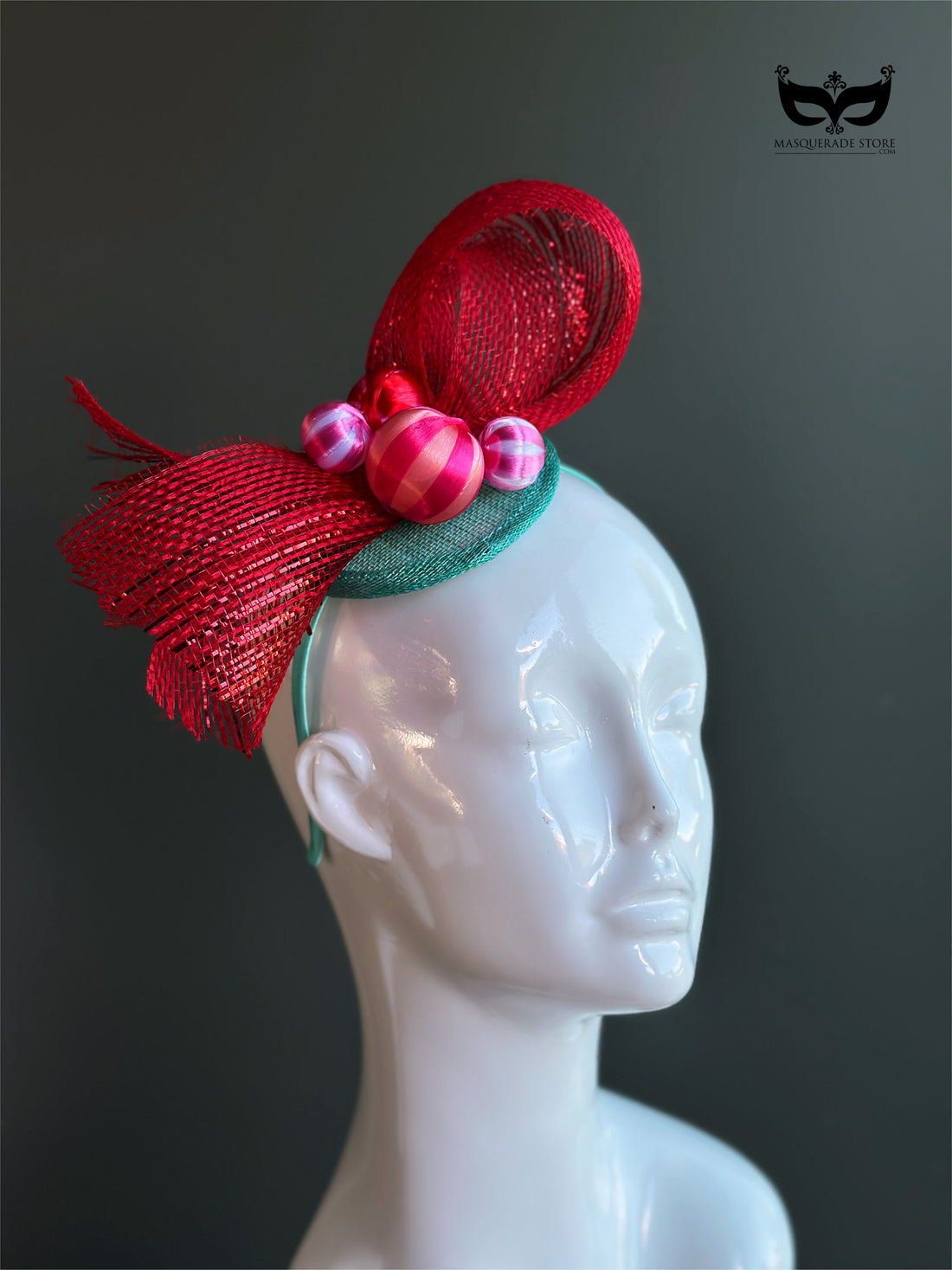 Red bow holiday fascinator headband with mesh loops and ornament bead accents on mannequin