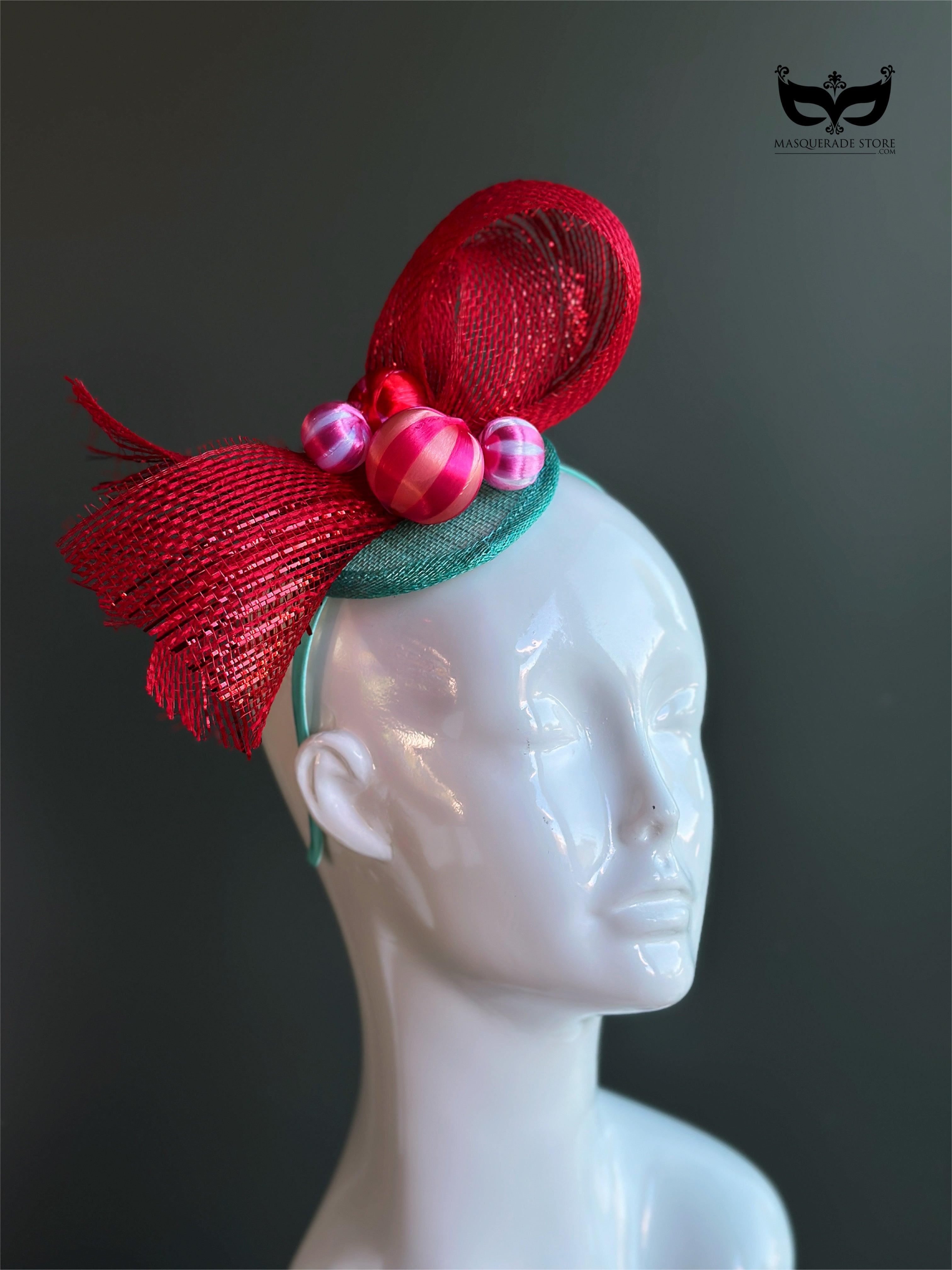 Red bow holiday fascinator headband with mesh loops and ornament bead accents on mannequin