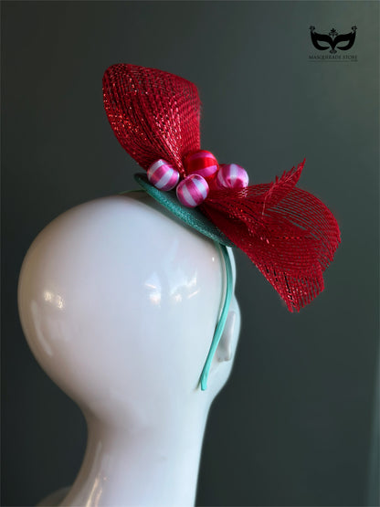 Red bow holiday fascinator headband with mesh loops and ornament bead accents on mannequin