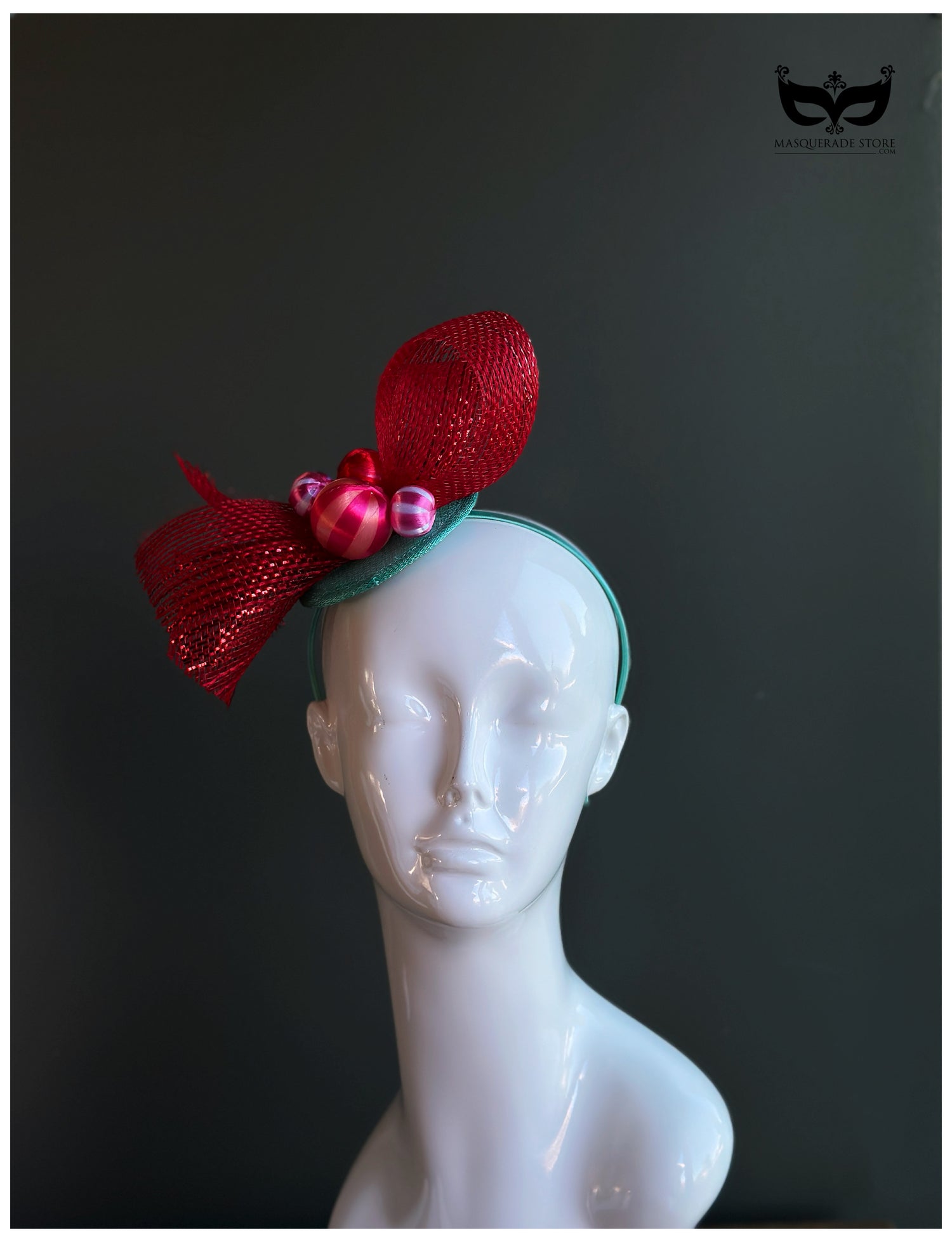 Red bow holiday fascinator headband with mesh loops and ornament bead accents on mannequin