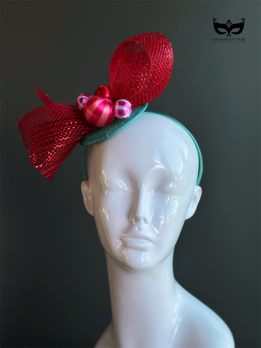 Red bow holiday fascinator headband with mesh loops and ornament bead accents on mannequin