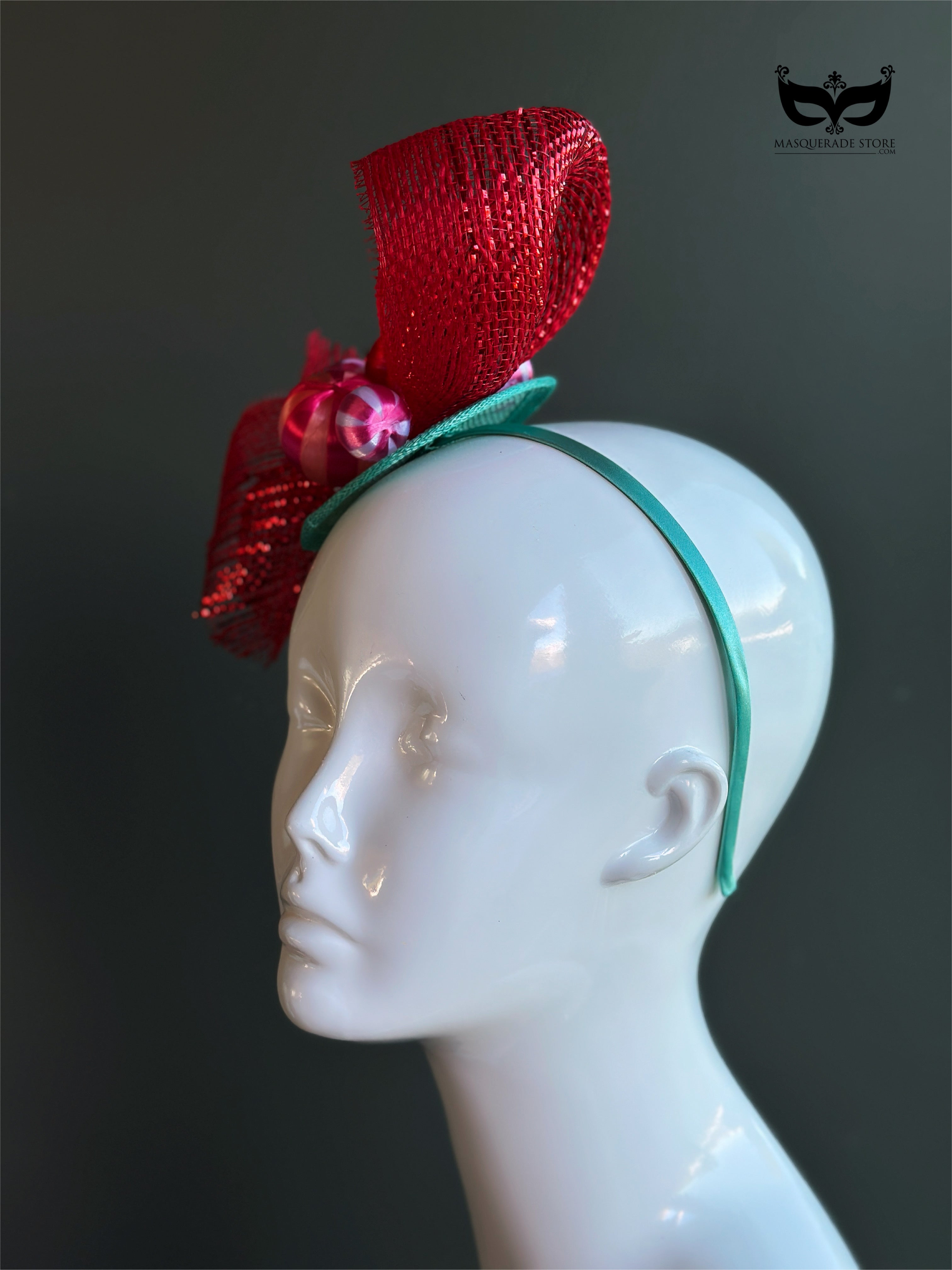 Red bow holiday fascinator headband with mesh loops and ornament bead accents on mannequin