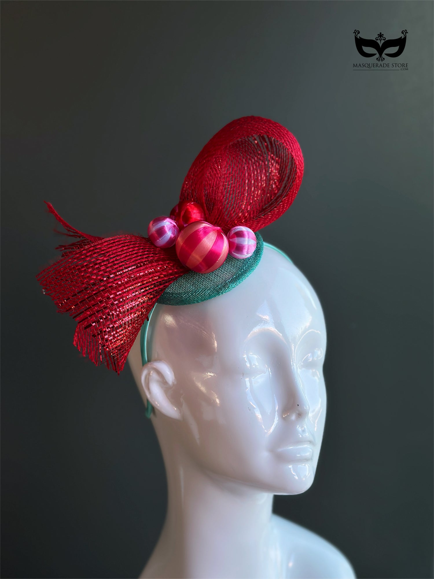 Red bow holiday fascinator headband with mesh loops and ornament bead accents on mannequin